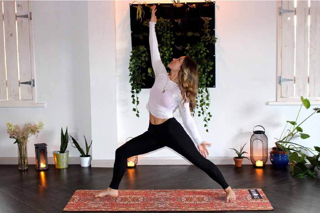 yoga teacher on yoga mat doing pose