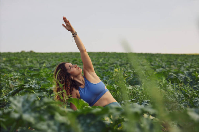 Yoga teacher practicing in green