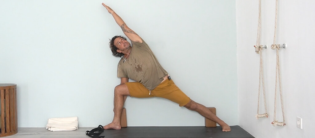 Iyengar Yoga Teacher Juan Carlos demonstrate a extended side angle pose