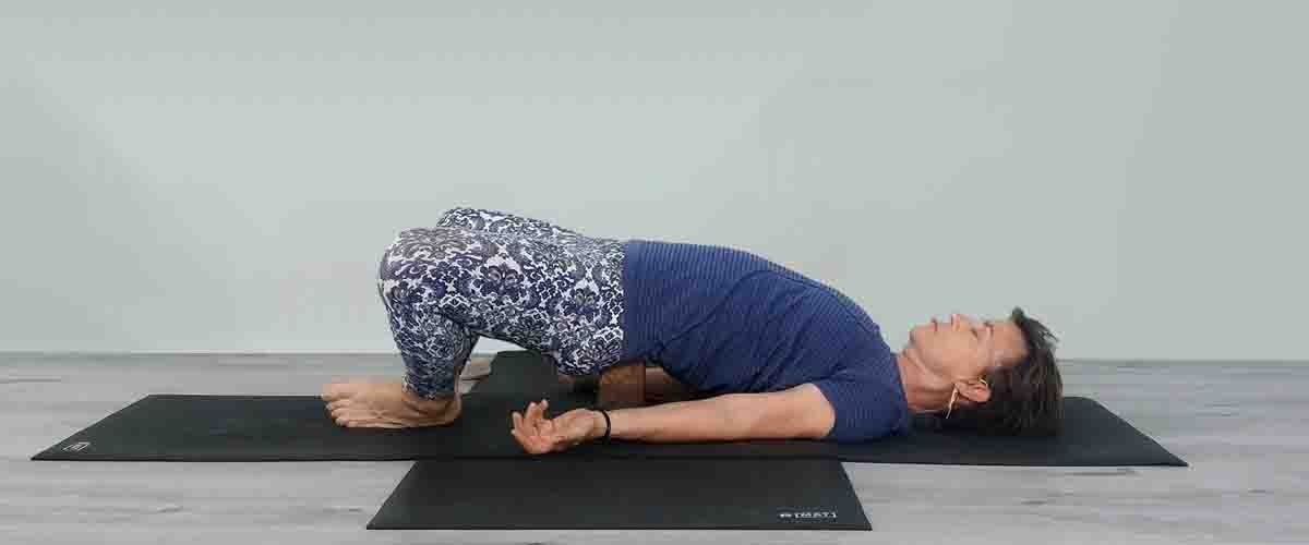 Senior Iyengar Yoga Teacher Kathy Cook demonstrate a Yoga pose