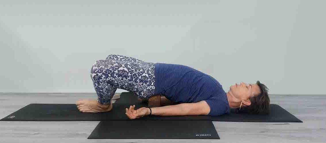 Senior Iyengar Yoga Teacher Kathy Cook demonstrate a Yoga pose