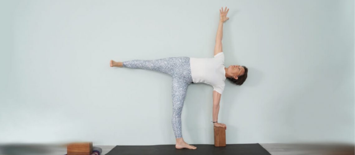 Senior Iyengar Yoga Teacher Kathy Cook demonstrate a Half Moon Pose