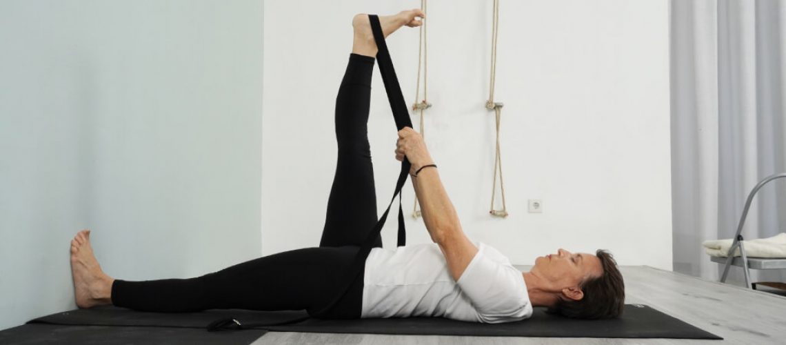 Senior Iyengar Yoga Teacher Kathy Cook demonstrate a Reclining Hand to Big Toe Pose