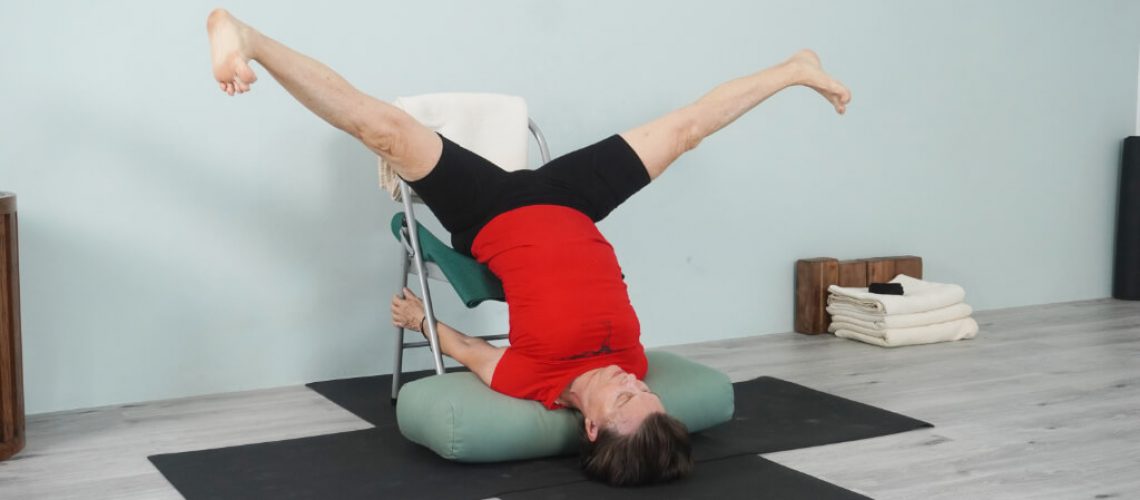 Senior Iyengar Teacher Kathy Cook demonstrate a Wide Leg Shoulder Stand Pose