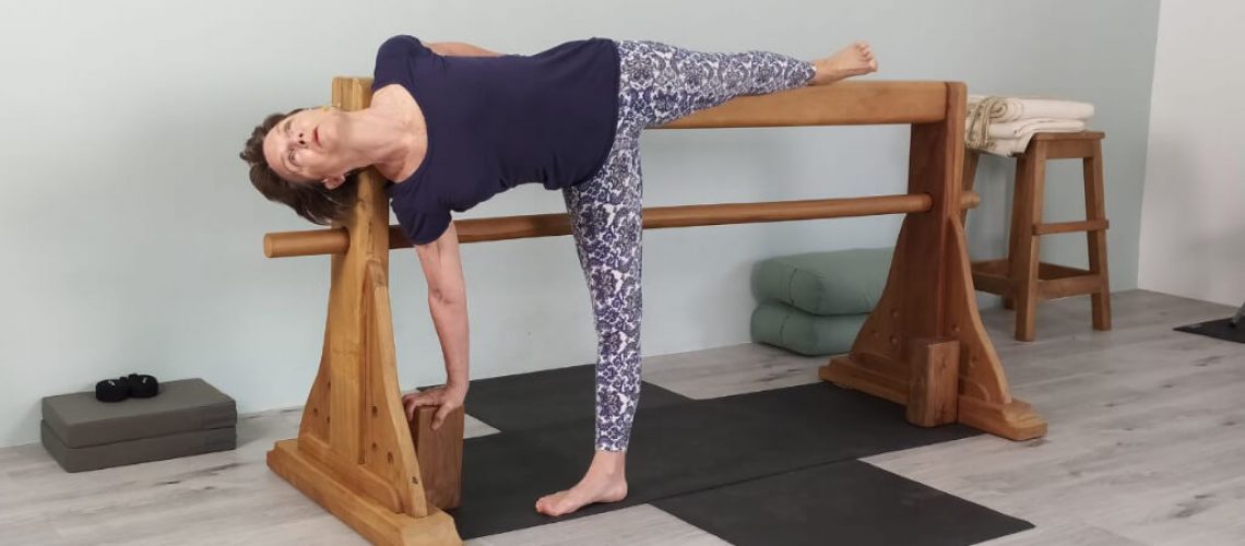 Senior Iyengar Yoga Teacher Kathy Cook demonstrate a Half Moon Pose