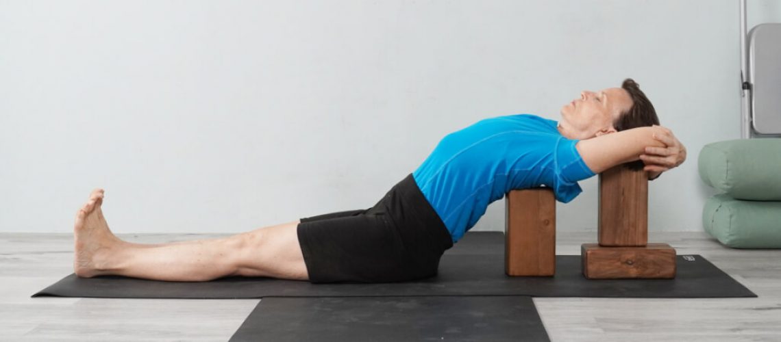 Senior Iyengar Yoga Teacher Kathy Cook demonstrate a Chest Opening Pose