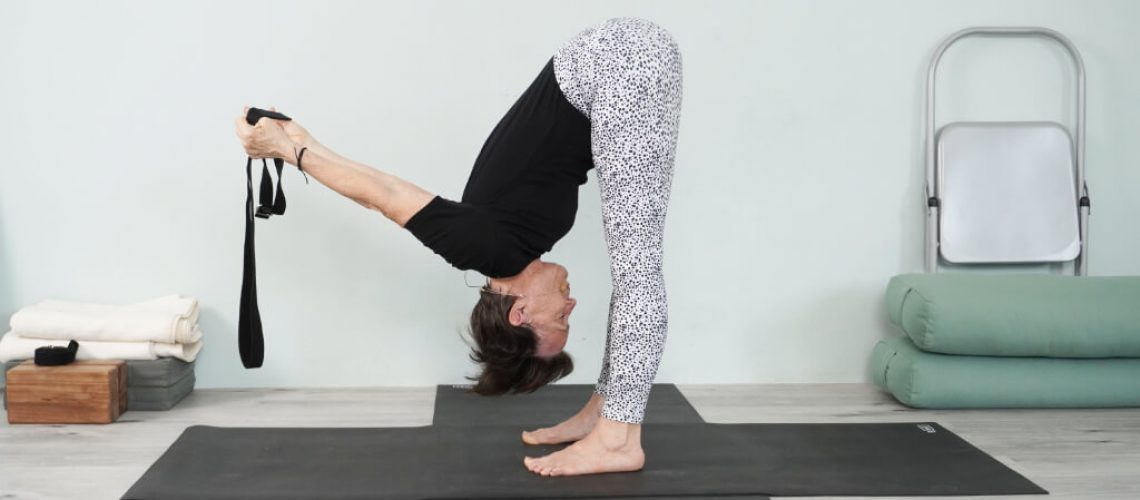 Senior Iyengar Yoga Teacher Kathy Cook demonstrate a Shoulder Stretch pose