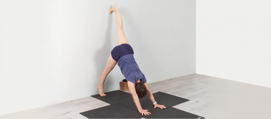 Senior Iyengar Yoga Teacher Kathy Cook demonstrate a One Legged Downward Dog Pose